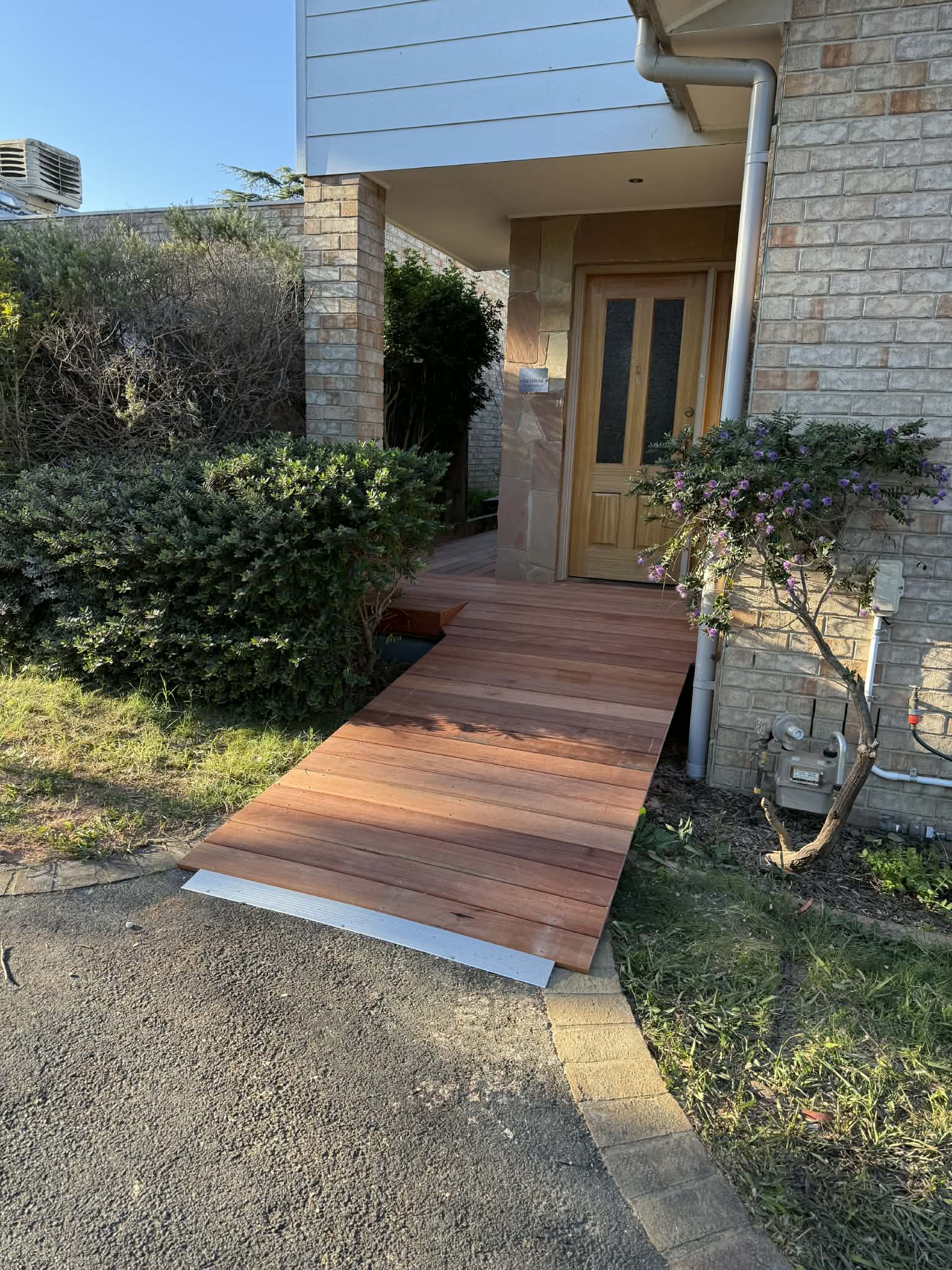 Karri ramp rising from the driveway to the front door at a wheelchair-friendly gradient